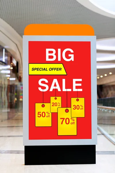 Billboard advertising big discount and sale in large store