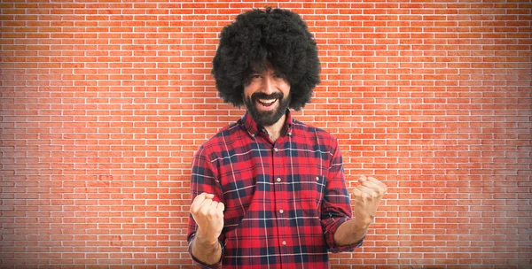 Lucky afro man over white background