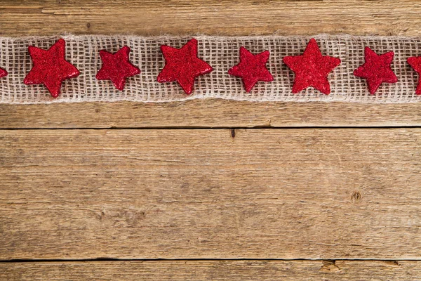 Wooden background with red stars