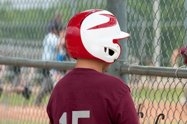 Youth baseball boy in dugout
