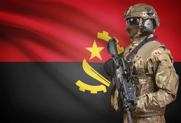 Soldier in helmet holding machine gun with flag on background series - Angola