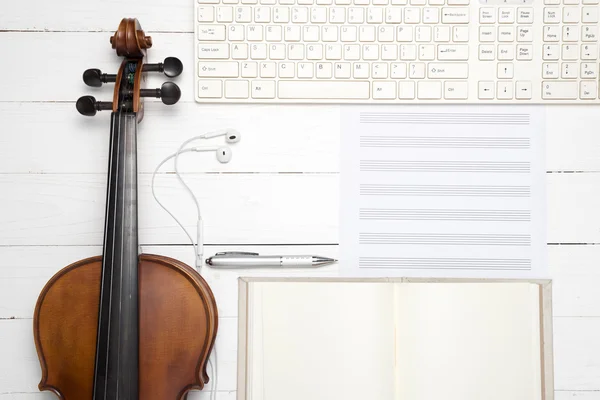 Violin with keyboard computer music paper note and notebook