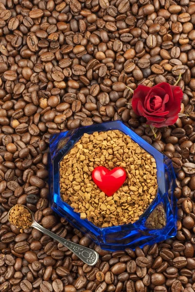 Coffee beans and instant coffee. Granules of instant coffee background. Instant coffee in a glass dish. Preparation of soluble coffee. Decorate store coffee.