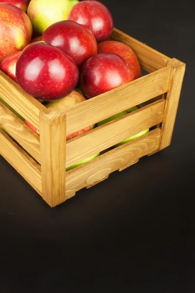 Fresh red autumn apples in farmhouse style wooden crate. Sales of farm products. Advertising for the sale of fruit.