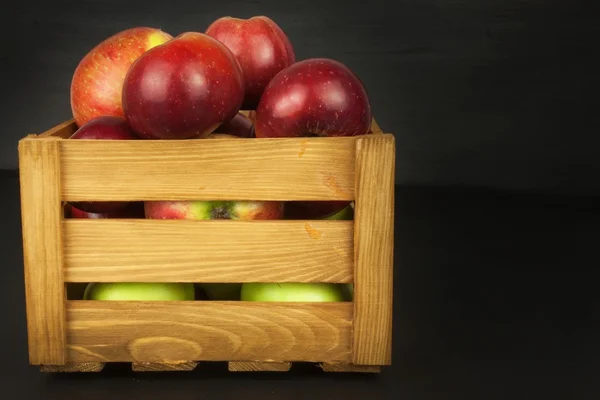 Fresh red autumn apples in farmhouse style wooden crate. Sales of farm products. Advertising for the sale of fruit.