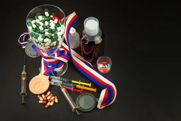Doping in sport. Abuse of anabolic steroids for sports. Anabolic steroids spilled on a wooden table. Fraud in sports. Pharmaceutical industry. False victory.