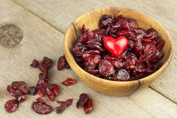 Dried cranberries in a bowl. Healthy super food. Dried cranberries on the kitchen table. Diet food.