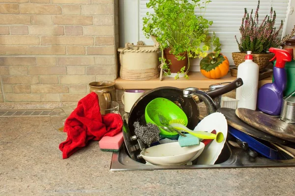 Dirty dishes in the sink after family celebrations. Home cleaning the kitchen. Cluttered dishes in the sink. Housework.