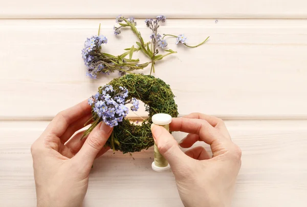Making wreath with forget-me-not flowers