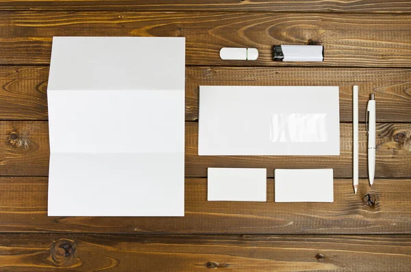 Blank stationery set on wooden background. ID template