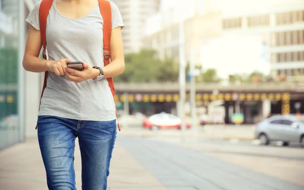 Woman walking with smart phone