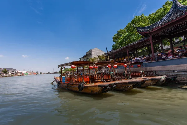 ZHUJIAJIAO, CHINA - AUGUST 30, 2016: Chinese gondolas waits Tourists on canal of ancient water town with a history of more than 1700 years in Zhujiajiao, China, on August 30, 2016.