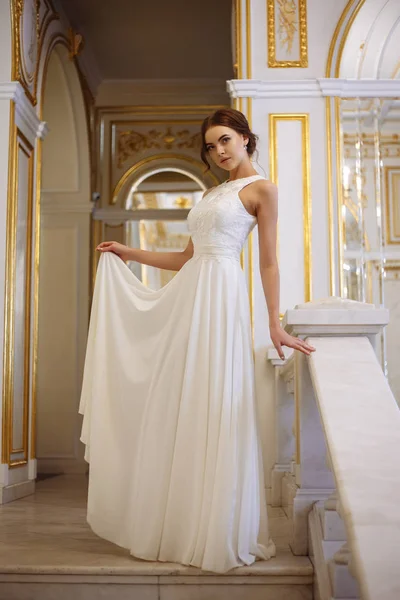 Beautiful young woman bride in luxury wedding dress in interior
