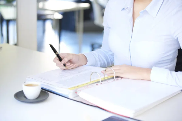 Businesswoman writing with  fountain pen