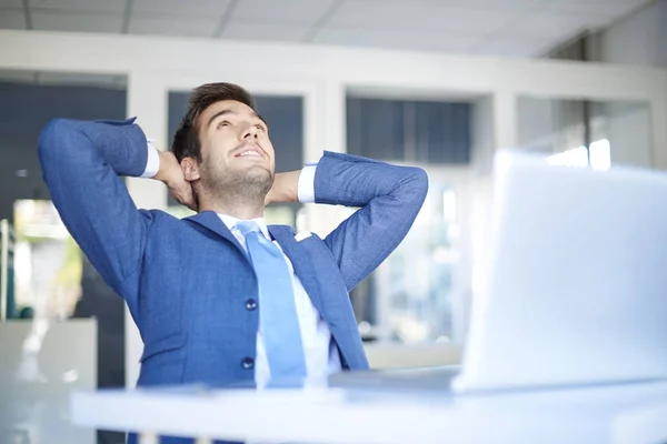 Successful businessman leaning back