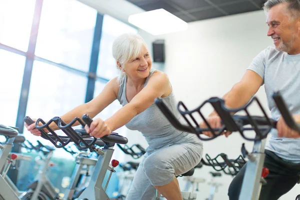 Senior couple exercising in gym