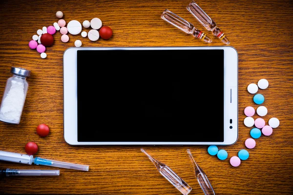 Tablet pc with medical objects on a desk