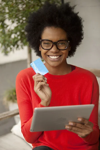 African american woman with tablet and credit card