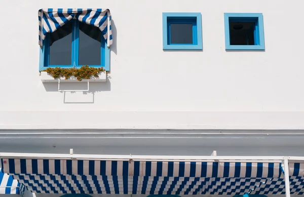 Blue windows and striped awnings