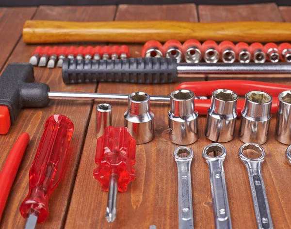 Set of different work tools on wooden surface