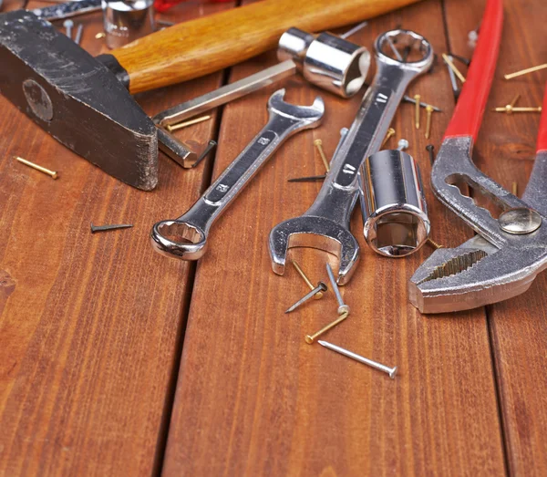 Set of different work tools on wooden surface