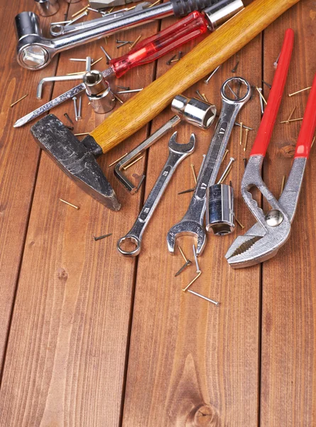Set of different work tools on wooden surface