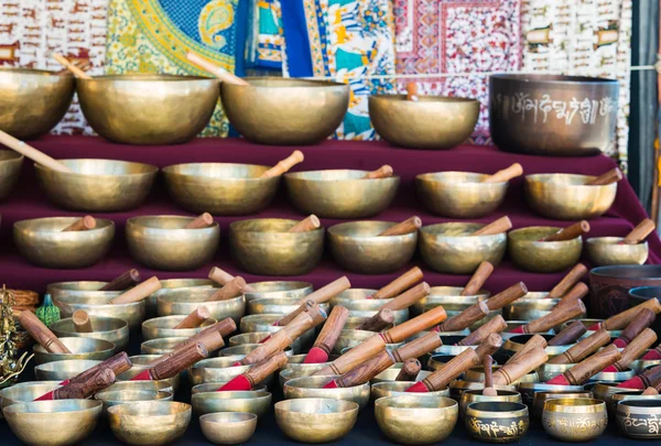 Tibetan singing bowls of various sizes in a market