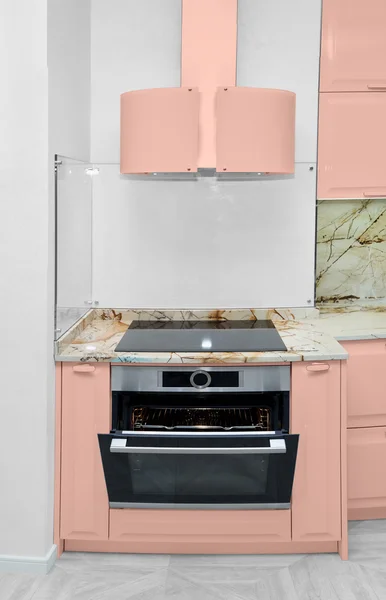 Oven with extractor fan in the kitchen. Minimalism