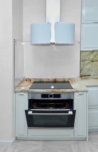 Oven with extractor fan in the kitchen. Minimalism