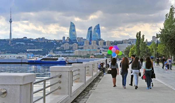 People goes by the seafront of Baku