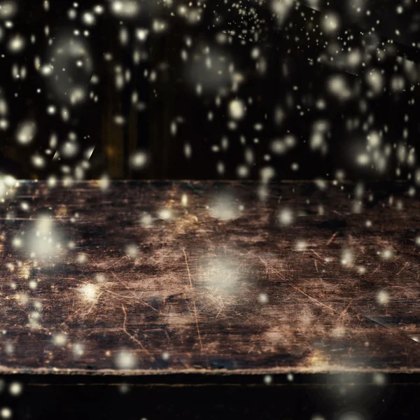 Empty wooden table with snow