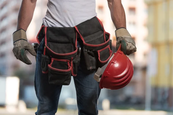 Close-Up Of Hard Hat Holding By Construction Worker