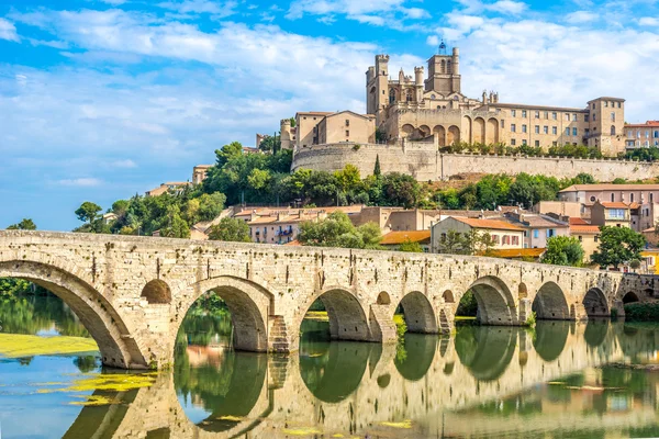 View at the Old Bridge over Orb river with Cathedral of Saint Nazaire in Beziers - France