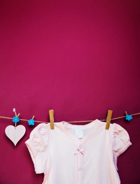 Baby clothes and goods hanging on the clothesline.