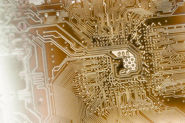 Close up of computer circuit board toned into golden or brown colors
