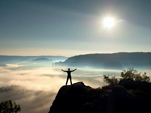 Happy man gesture of triumph with hands in the air. Funny hiker with raised arm