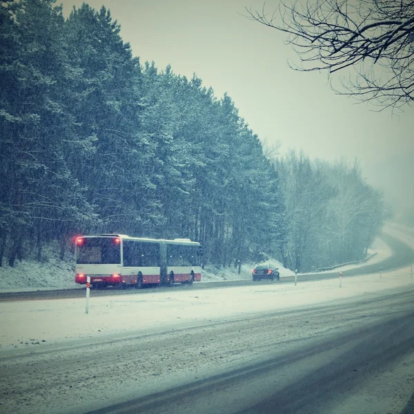 Cars in the fog. Bad winter weather and dangerous automobile traffic on the road. Light vehicles in fog.