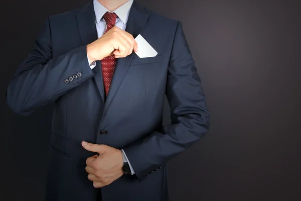business man taking out business card from the pocket of business  modern suit