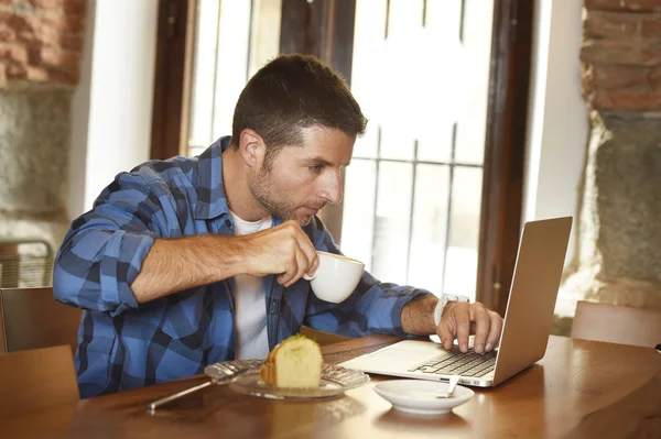 Businessman or student working with laptop computer at coffee shop having breakfast