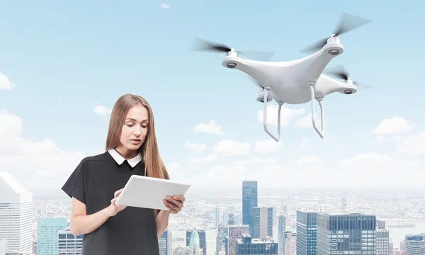 Young woman controlling a drone in big city