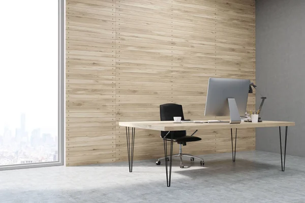 Side view of CEO working desk in office with wooden panels