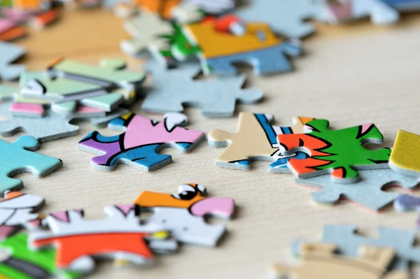 Children\'s puzzles on a wooden background close up
