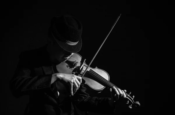 Violin player in dark studio