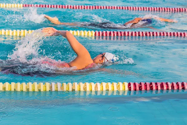 young man swimming front crawl in the pool