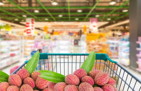 Ripe litchi fruits in shopping trolley cart  in supermarket