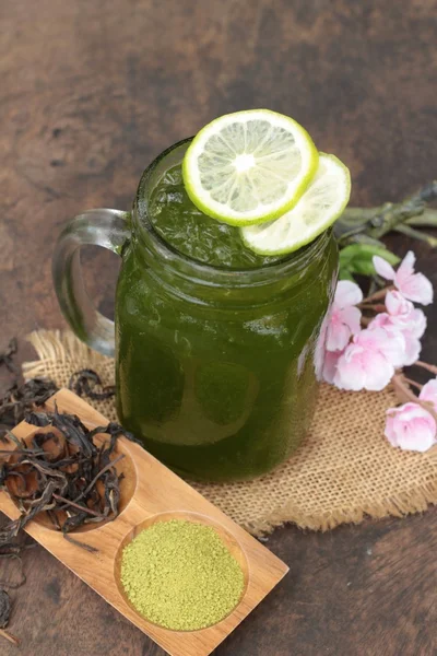 Iced green tea with lemon and matcha tea powder.