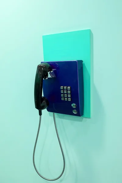 Blue phone on a wall