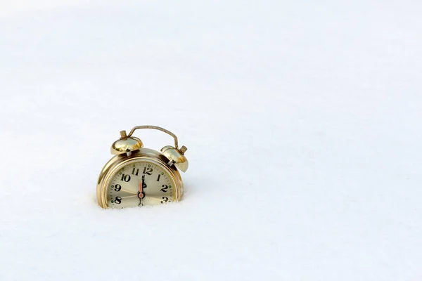 Old clock in the pure white snow