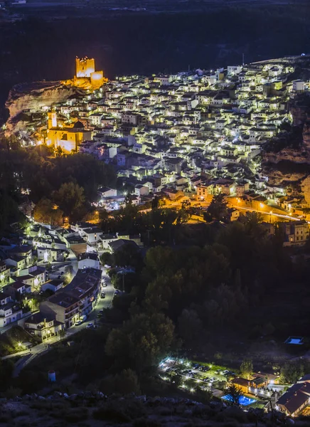 Night view of the city, on top of limestone mountain is situated Castle of the 12TH century Almohad origin, take in Alcala del Jucar, Albacete province, Spain