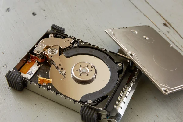 Close Up of Broken and Destroyed Hard Drive Disk on Wooden Table